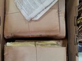 a box full of books and papers sitting on a table