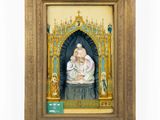 an old picture of a woman holding a baby in a gold frame