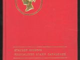 a red book with a gold medallion on the cover
