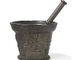 an old mortar with a pesticider in it on a white surface