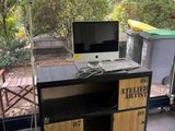 a desk with a computer on it in front of a window