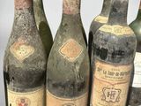several bottles of wine are lined up in a row on a table