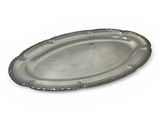 an oval silver tray with a beaded edge on a white background