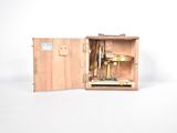 a small wooden box with a machine inside of it