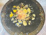 a black table with yellow flowers painted on it