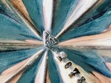 a close up of a painting of a flower with words on it
