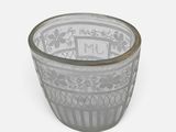 a glass bowl with a design on it on a white surface