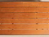 a wooden board on a table with a cup of coffee on it