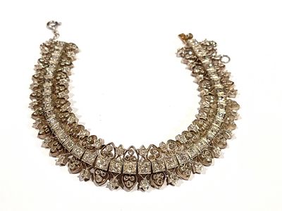 a close up of a necklace on a white surface