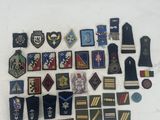 many different military badges on a white surface