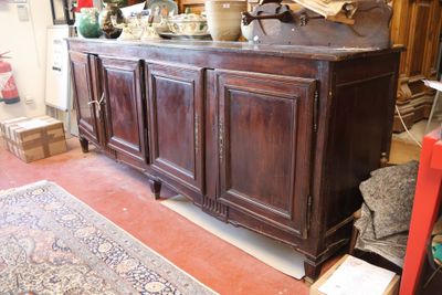 a large wooden cabinet in a room with a rug on the floor