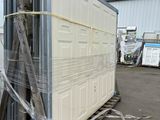 an image of a container being loaded with a sheet of plastic