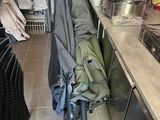 several umbrellas are lined up on the floor in a kitchen