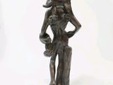 a bronze statue of a woman holding a flower
