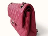 pink quilted purse on a white background with a white background