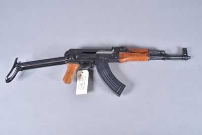 a close up of a gun on a table with a tag on it