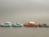 several toy cars are lined up in a row on a gray surface