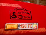 a close up of a badge on the back of a red car