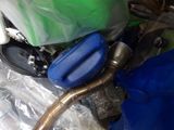 a pile of assorted items that include a hose and a blue bag