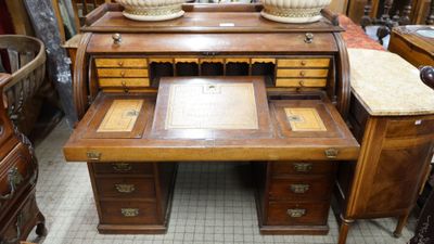 a wooden desk with a marble top in a room
