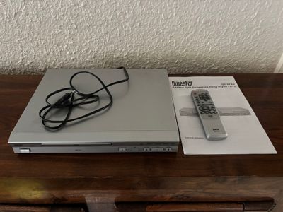 a laptop and a remote sitting on a wooden table