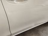 a white car with a hole in the side of it