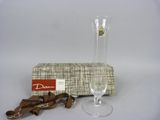 a wine glass and a pair of shoes next to a box