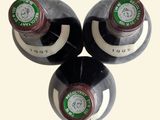 three bottles of wine sitting on top of each other