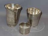 three pieces of silverware sitting on top of a white surface