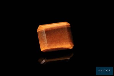 a close up of a wooden block on a black surface