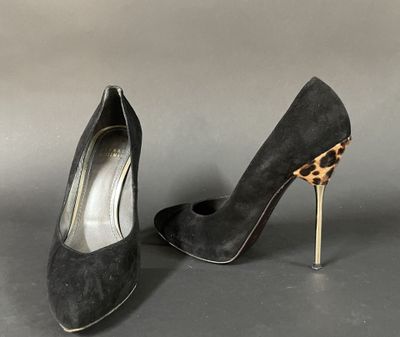 a pair of black sued heels with a leopard print heel