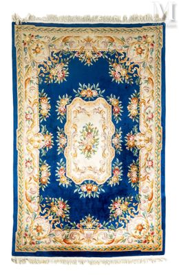 a blue and gold rug with a floral design on it