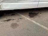 a car that is parked in a parking lot with a lot of dirt on the ground