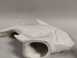 a white ceramic object that looks like a fish
