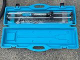 a blue tool case with tools in it on the ground
