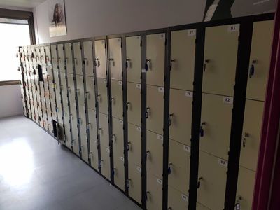 a long row of lockers in a room with a lot of doors