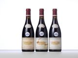 three bottles of wine are lined up on a table