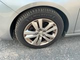 a close up of a tire on a silver car