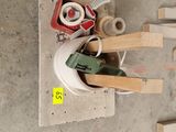 a pile of tools sitting on the floor next to a pile of pallets