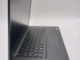 a laptop computer sitting on a table with a keyboard