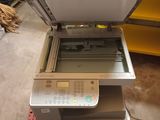 a printer sitting on top of a pallet in a warehouse