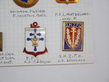 a lot of badges on a piece of paper on the wall