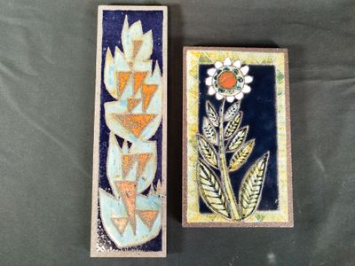two boxes that have flowers on them on a table