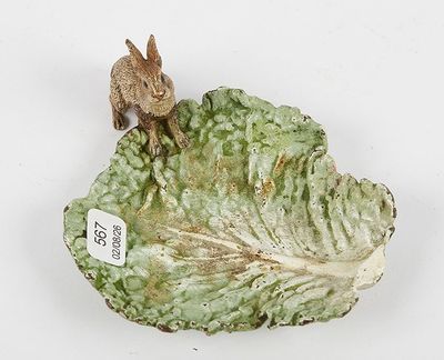 a figurine of a rabbit on top of a cabbage leaf