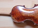 a violin that is sitting on a wooden floor