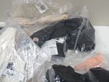 a pile of clothing wrapped in plastic bags on a table