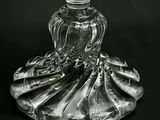 a glass vase with a piece of cake in it