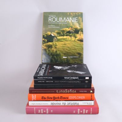 several books stacked on top of each other on a white surface