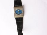 an image of a black watch with a blue face on a white surface