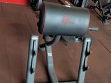 an image of a gym room with a bench and weights